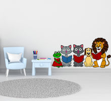 Load image into Gallery viewer, A colorful wall decal of six cartoon animals a lion, a dog, a frog, and two cats reading books. The animals are arranged in a line, with the lion on the right side of the image, the cats and dog in the middle, and the frog on the bottom left side.