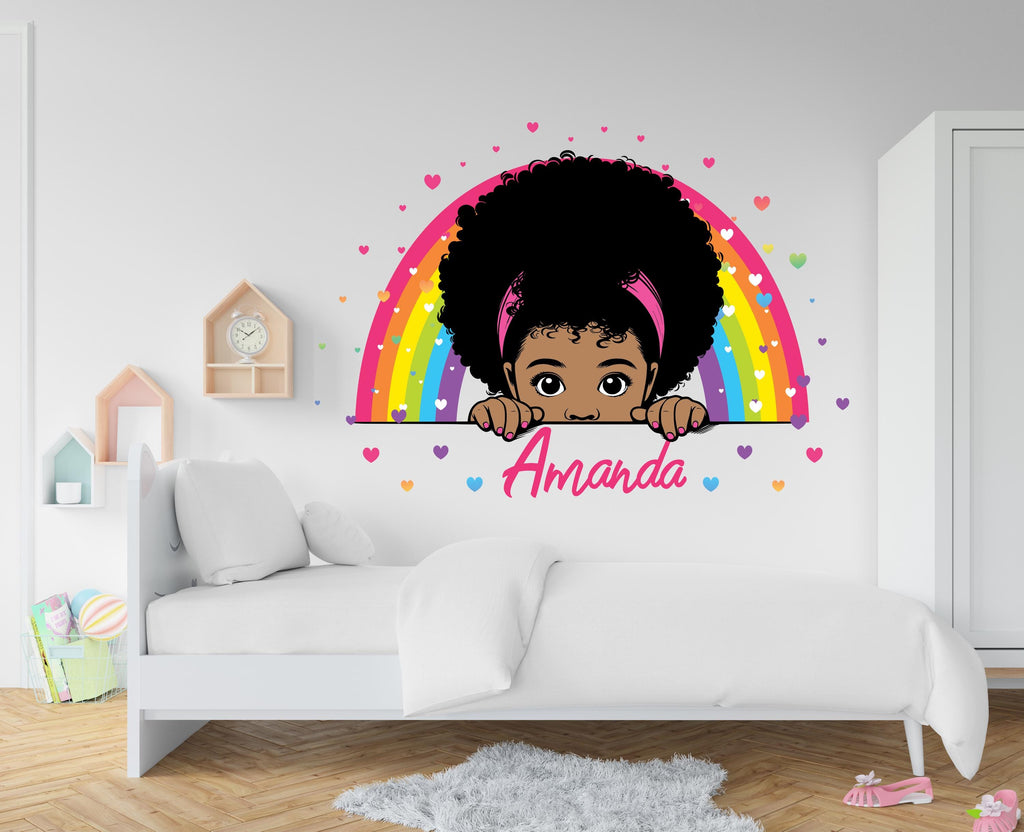 May include: A colorful rainbow with hearts and a girl with an afro peeking over the top. The name "Amanda" is written below the rainbow.