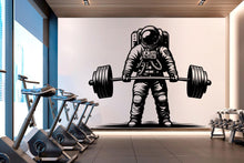 Load image into Gallery viewer, May include: Black and white illustration of an astronaut lifting a barbell in a gym setting. The astronaut is wearing a spacesuit with a helmet and is lifting the barbell with both hands. The barbell is made up of two weights and a bar. The illustration is on a white wall in a gym with exercise equipment in the foreground.