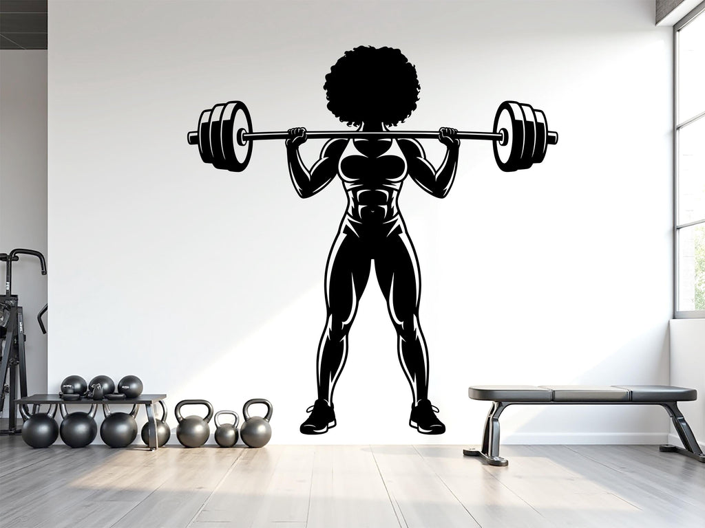 May include: Black and white illustration of a muscular person lifting a barbell overhead. The figure has an afro and is wearing athletic attire. The image is a silhouette, suitable for gym decor or fitness-themed designs.