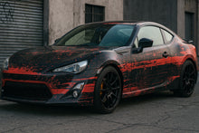 Load image into Gallery viewer, Red Distressed Street Wrap – Matte Black &amp; Crimson Vinyl | Grunge Brush Texture Car Design | Custom Urban Performance Wrap by Stickalz nv099